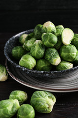 Plate with fresh brussels sprouts on table, closeup