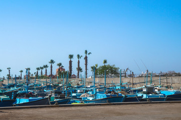 Fototapeta na wymiar Lots of blue various fishing boats, Fishermen?s vehicles in Egypt at the port of the fish market. Stock photos