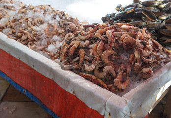 Various shrimps on the market near the sea, the ocean. Old stalls with fresh marine life. Asia culture and traditions. Stock photos