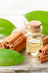 cinnamon oil in the glass bottle, on the wooden board