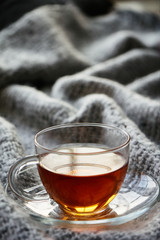 Cup of tea./A Cup of tea is on a woolen blanket.