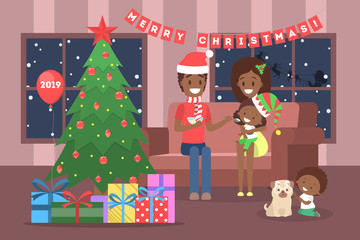 Family have fun together at christmas tree