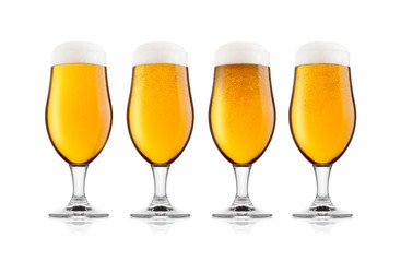 Cold glasses of lager beer with foam and dew