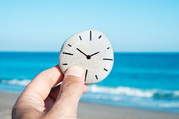 man and a stone with a clock drawn in it