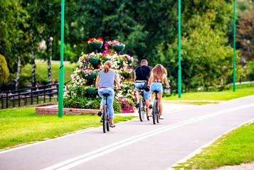 Cyclists ride on the bike path in the city Park 