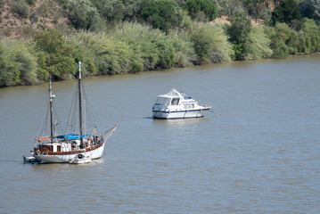 sailboat and motorboat moored on Rio Guadiana