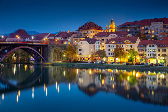 Maribor, Slovenia. Cityscape image of Maribor, Slovenia during autumn twilight blue hour with reflection of the city in Drava River.