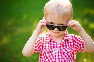 funny little boy in sunglasses. Child boy in sunglasses