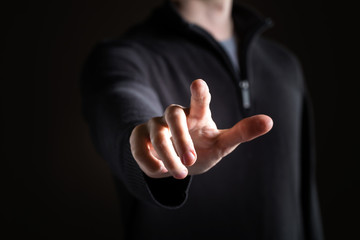 Man pointing or pressing something on black background