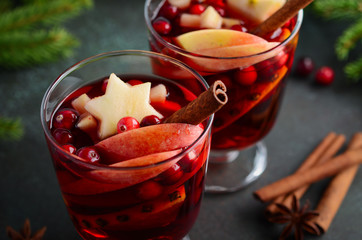 Christmas Mulled Wine with Apple, Orange and Cranberries. Holiday Concept Decorated with Fir...