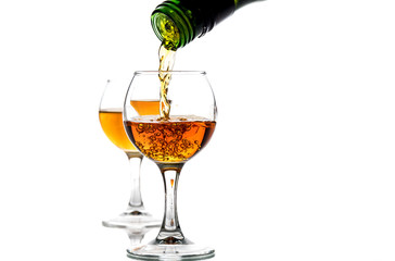 A round glass with brandy and a splash of drink inside