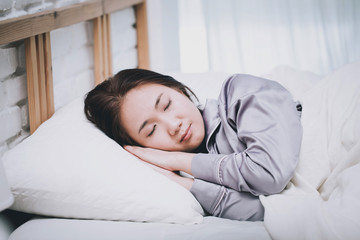 Beautiful Attractive Asian woman sleep and sweet dream on bed in bedroom in the morning,Healthcare Concept