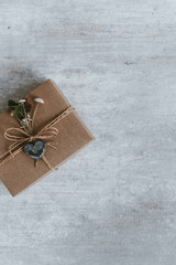 Handmade christmas gift or present box wrapped in kraft paper. Top view, flat lay, copy space. Greeting card