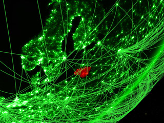 Lithuania on green model of planet Earth with network at night. Concept of green technology, communication and travel.