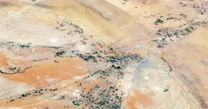 Very high-altitude circular tracking shot of Arabian Desert farms. Reversible, seamless loop. Elements of this image furnished by NASA
