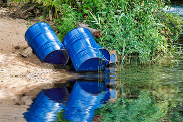 blue oil drums thrown in the water