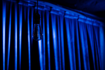 Light bulb on blue background