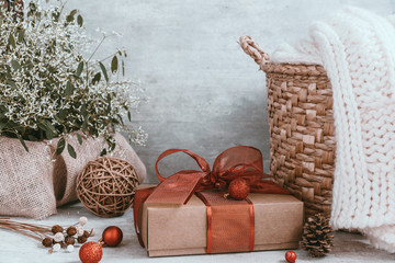 Beautiful Christmas background with decorations and gift boxes on wooden board. Red ribbon, pine cones, baubles. Copy space, greeting card