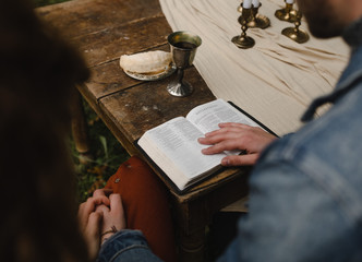 christian couple reading the bible and taking communion