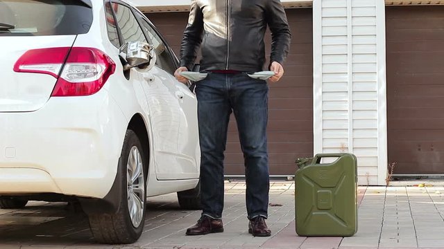 Expensive fuel prices. after refueling the car, the driver shows empty pockets. fuel price concept