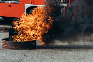 close up view of burning flame and fire truck on street