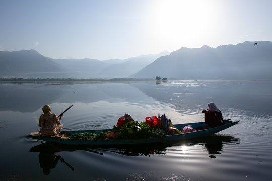 Women with vegetables on boat at Dal lake, Kashmir, India