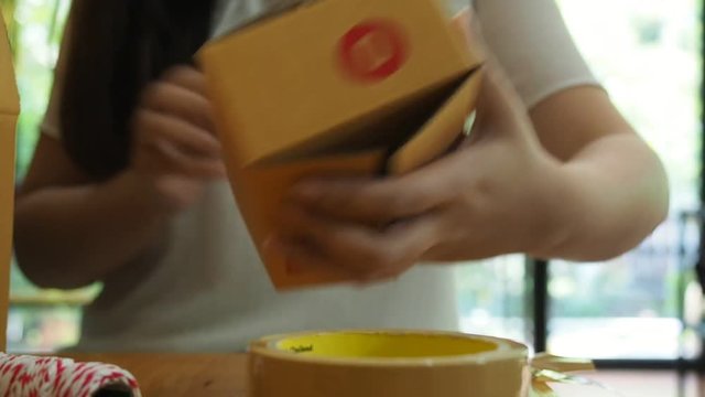 Business owner work at home wrapping parcel box, Alpha generation life style. Business woman entrepreneurial successful. Sales Online Parcel delivery. New generation life style of young entrepreneur.