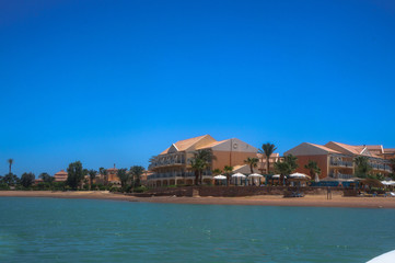 Beautiful view of the coastline with houses and hotels on the red sea. Tourist region in Egypt. Hurghada and its traditions. Stock photo for design