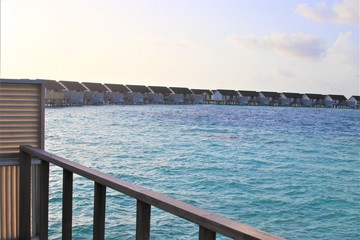 Obraz premium Overwater villa and tropical beach in the Maldives