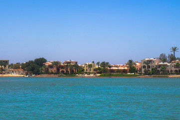 Beautiful view of the coastline with houses and hotels on the red sea. Tourist region in Egypt. Hurghada and its traditions. Stock photo for design