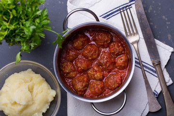 close up of meatballs, tomato sauce and mash
