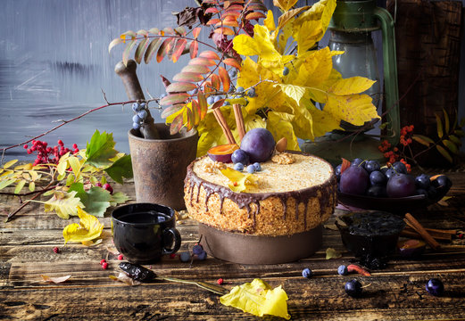 Autumn composition with plum cake with chocolate and nuts, rustic