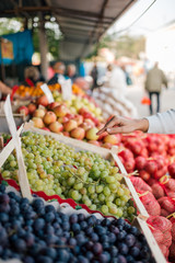 Buying grapes at local food market.