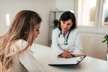 Young female patient listening to her doctor.