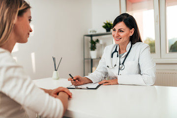 Young woman visiting doctor. Copy space.