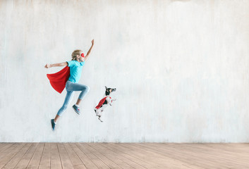 Jumping little child with a dog