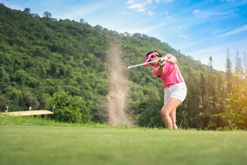 Selbstklebende Fototapeten Young women player golf swing shot on course in morning sunrise © Aunging