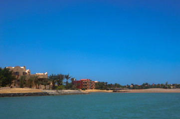 Beautiful view of the coastline with houses and hotels on the red sea. Tourist region in Egypt....