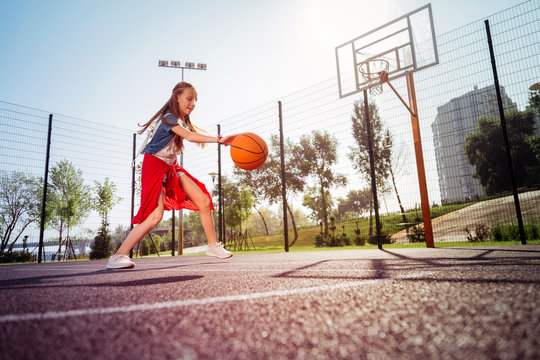 Be active. Kind teenager expressing positivity while playing basketball