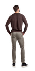 A back view on a modern fit and casually clothed man that stands in a relaxed posture and looks...