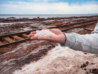 salt extraction old rusty railroad tracks on gravel embankment at salt mining site Lake Baskunchak