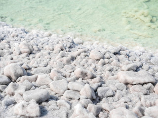 The stones are covered with a crust of salt on the shores of the salar Baskunchak. Extraction of salt