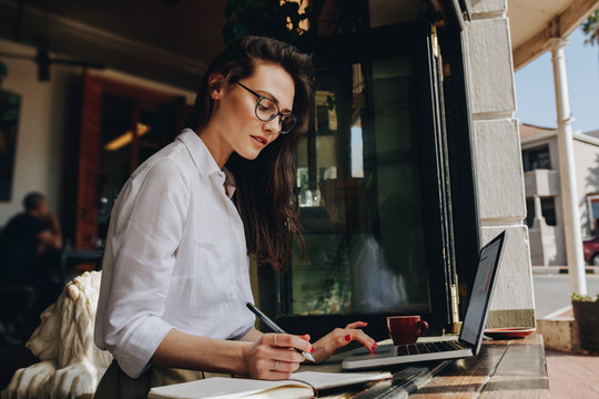 Businesswoman Working From A Coffee Shop