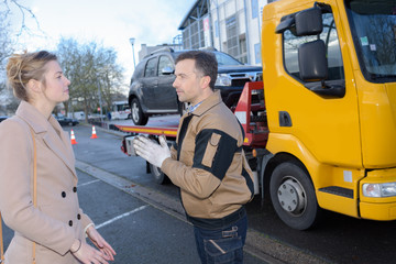 car towing worker talking to customer
