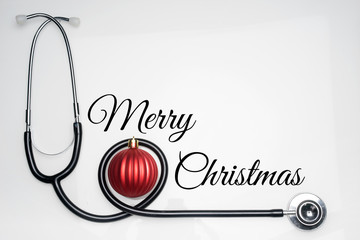 Christmas in the healthcare industry. Top view of flat lay. Stethoscope with ornaments carries an...