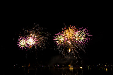 Fototapeta na wymiar Germany, Magnificent fireworks show of rocket explosion in the night at Friedrichshafen