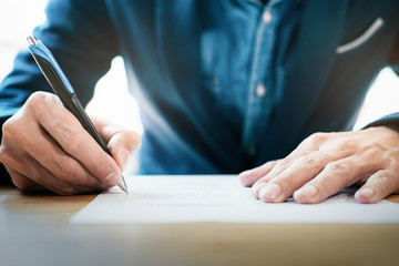 Close up businessman signing contract making a deal