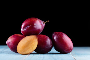 Sweet plums on wooden background