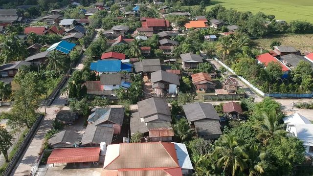 aerial view of countryside village in Thailand. Pan shot by drone