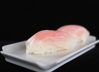 Close up delicious sushi over dark background copy space.
